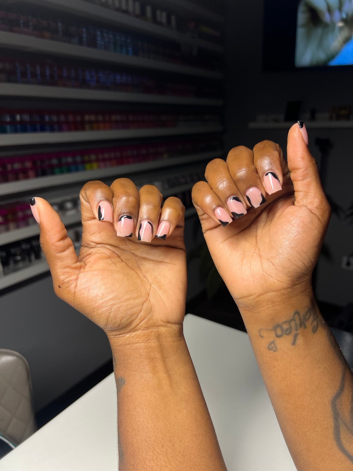Soft pink nails with fine black line art on both hands
